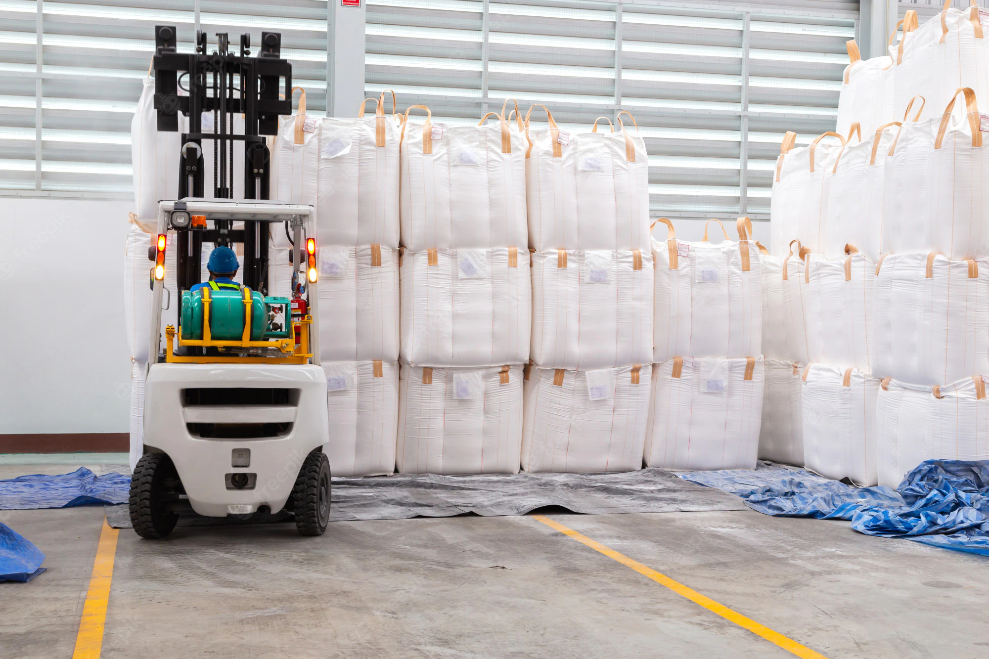 forklift-is-handling-jumbo-bags-large-warehouse_38076-1575